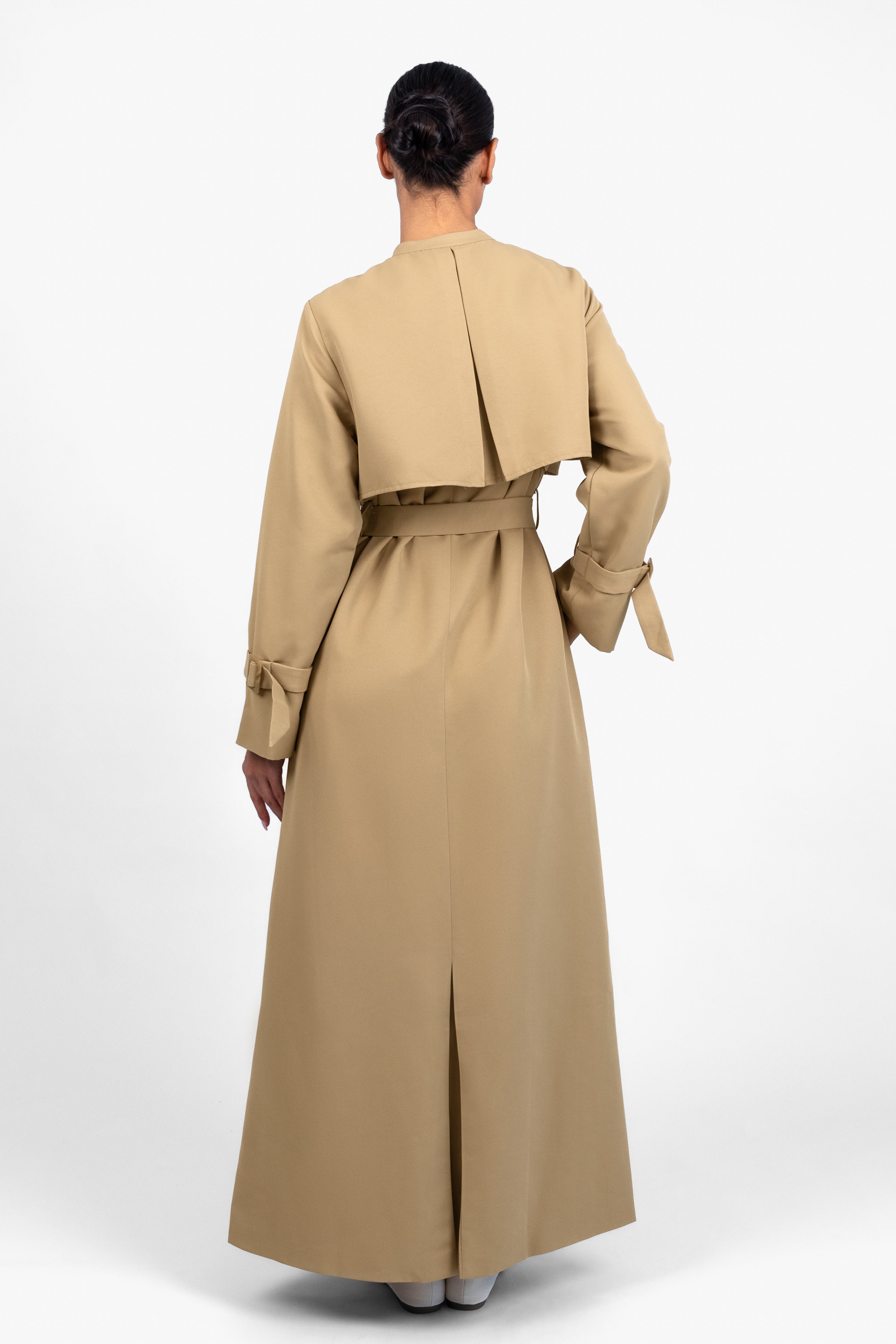 Colour: Tan. A model from behind in a Trench Coat Dress.