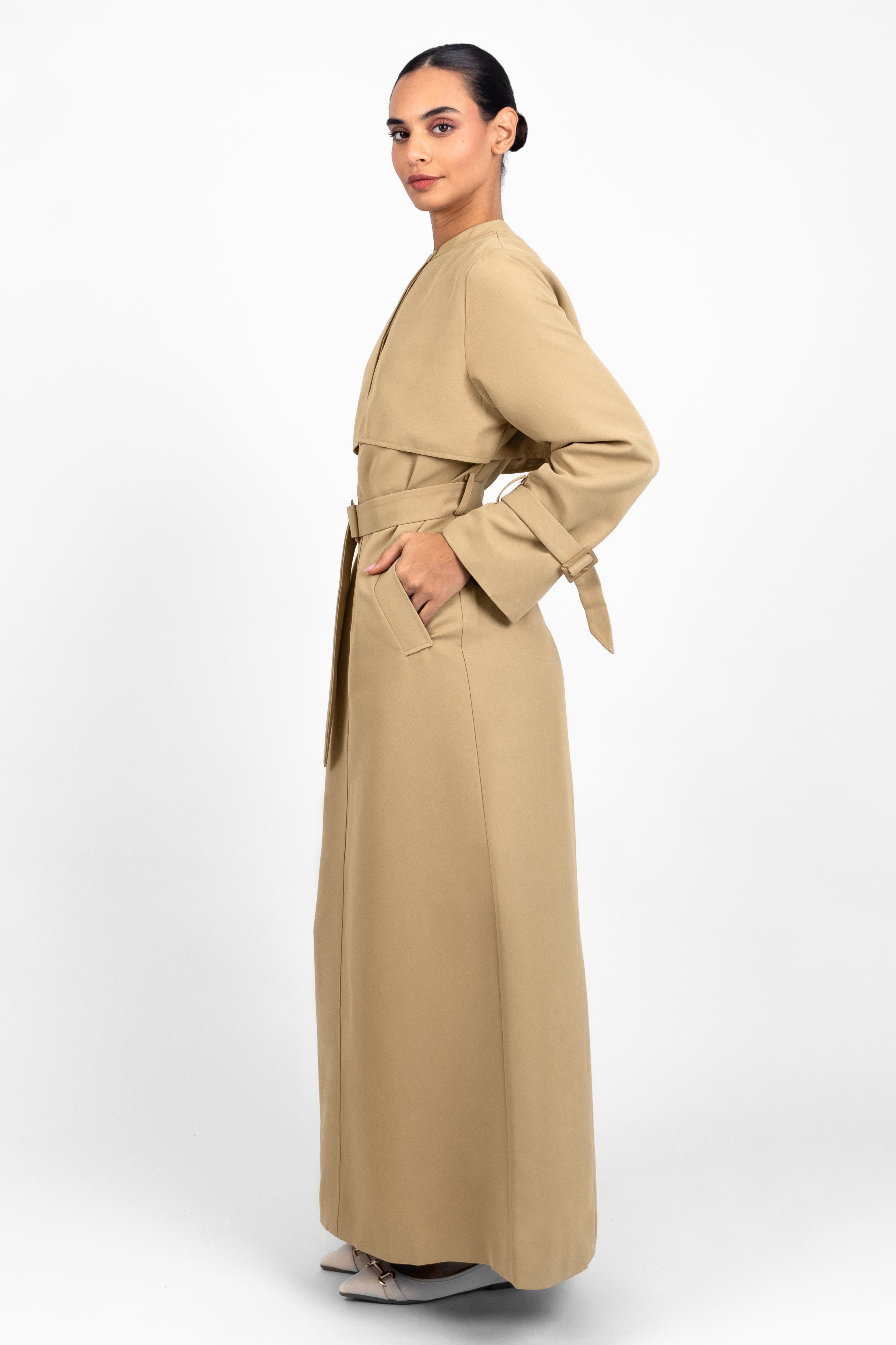 Colour: Tan. A woman in a side pose wearing a Trench Coat Dress.