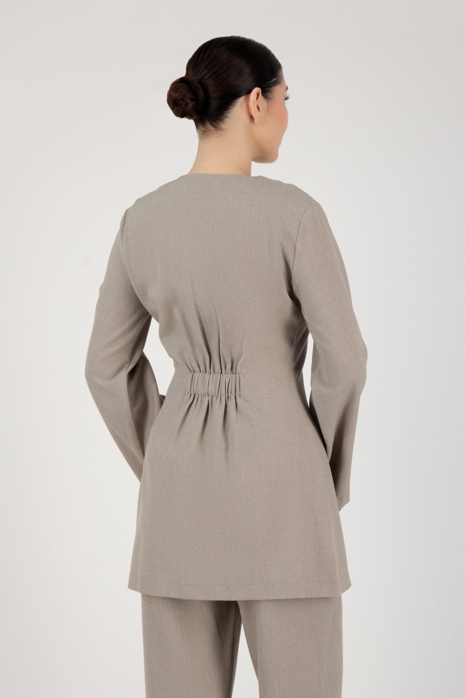 Back view of the FARES Tailored Button-Up Tunic in Stone highlighting structured tunic clothing with a smooth, tailored fall.