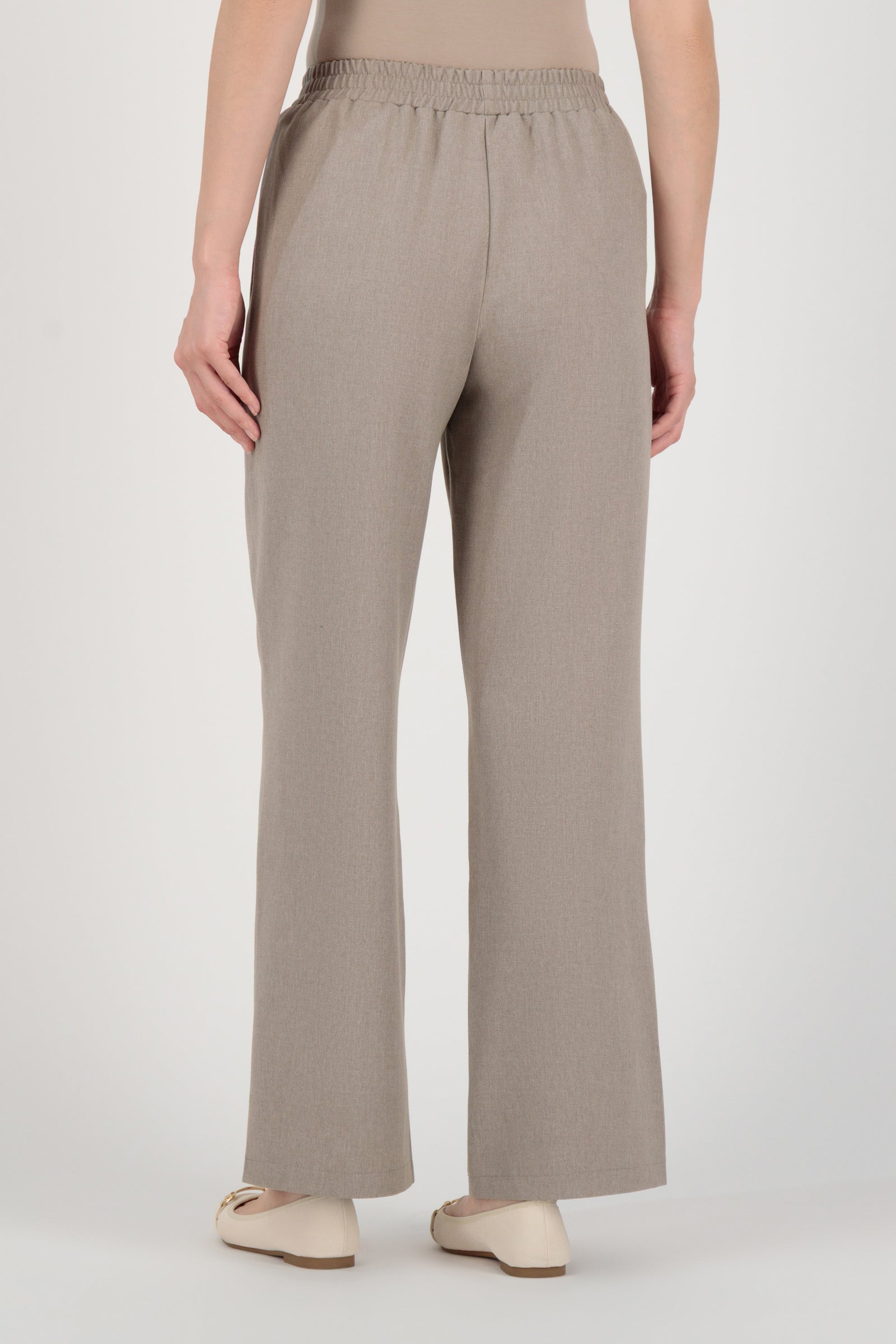 Back view of the FARES Tailored Elastic Waist Pants in Stone highlighting smooth tailoring and the easy structure of elastic waist pants.