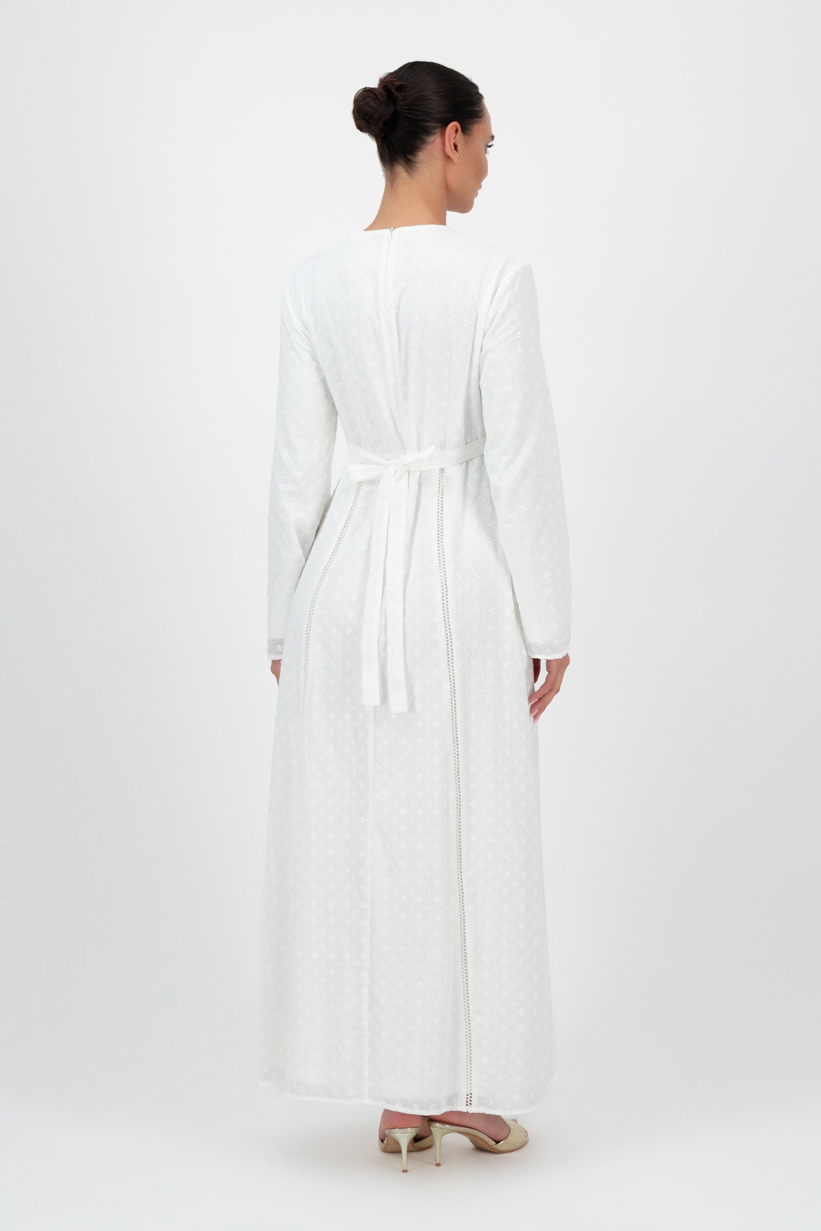 Back view of the FARES Embroidered Floral Dress in White showcases the graceful drape and intricate detailing that define this modest floral dress.