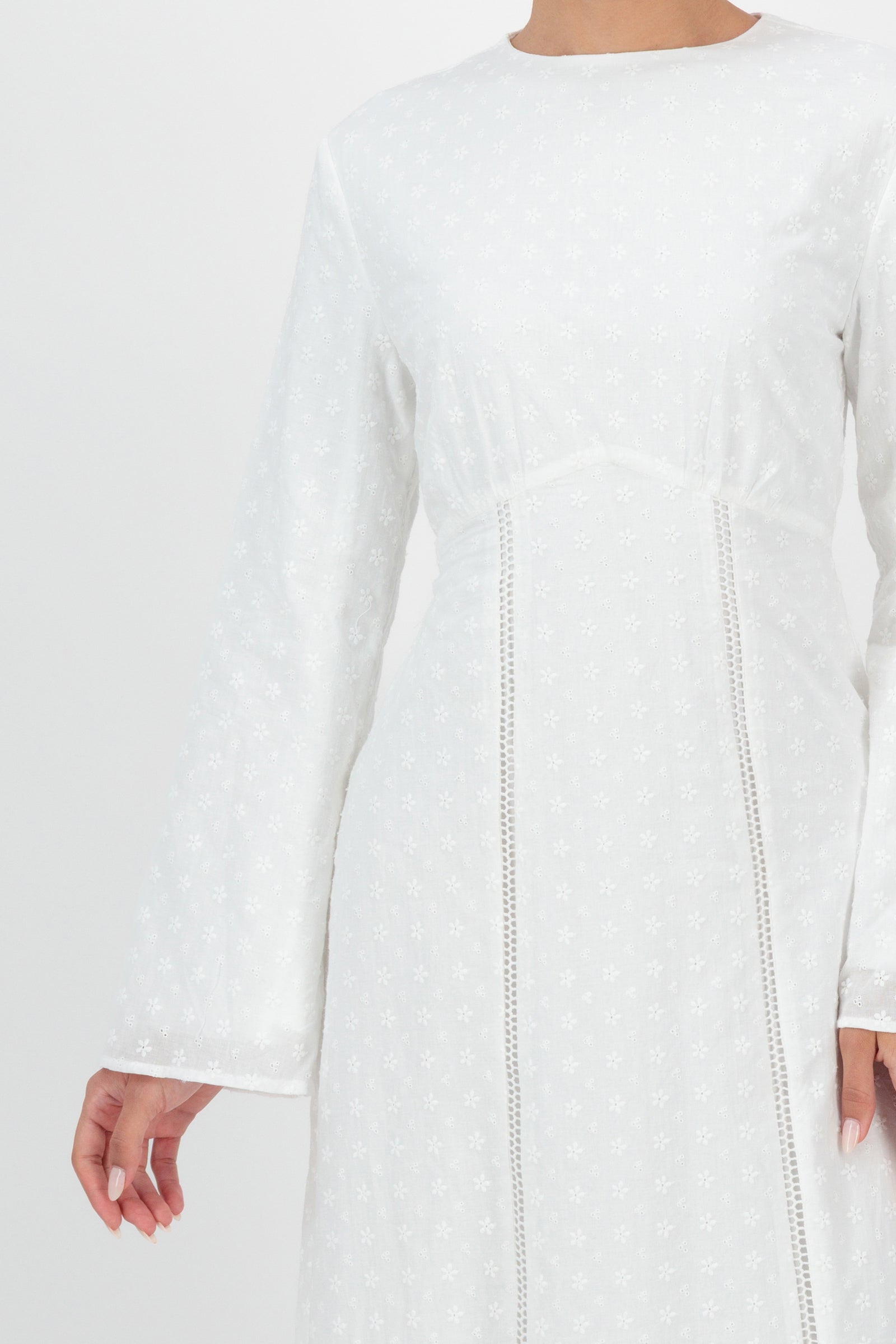 Close-up detail of the FARES Embroidered Floral Dress in White captures the fine embroidery and soft fabric finish that elevate this classic floral dress.