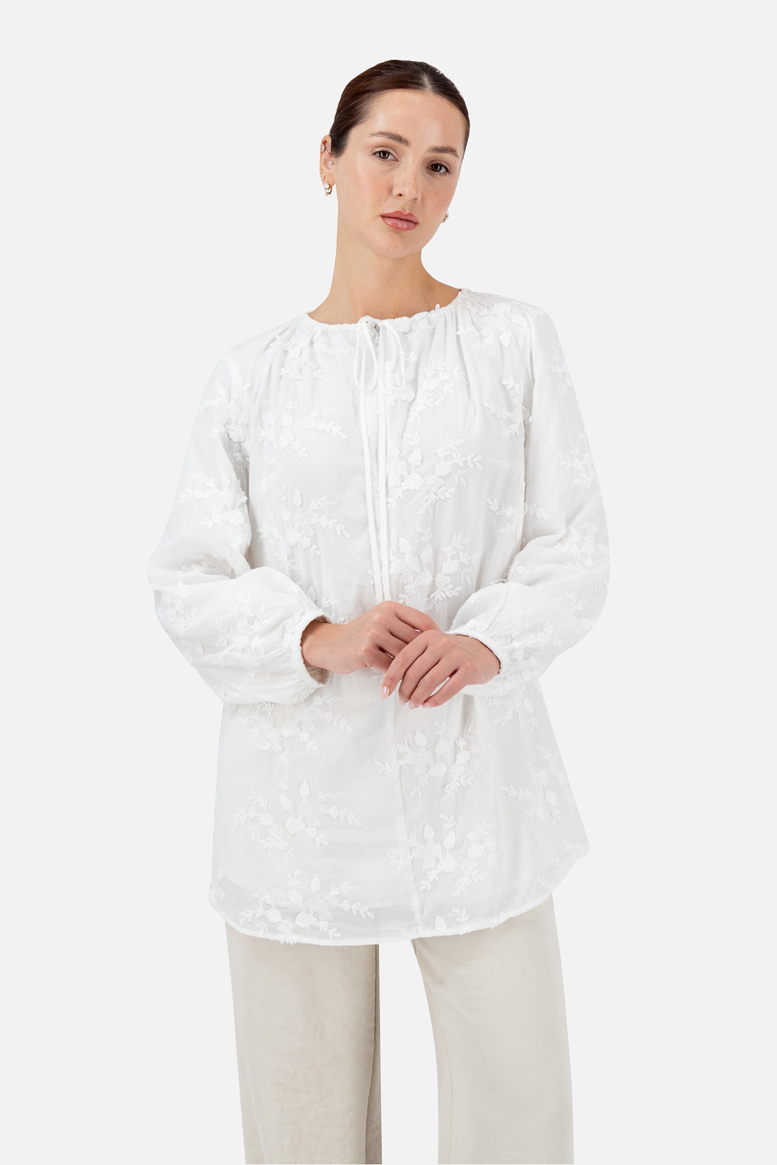 White floral embroidered blouse for women with a relaxed fit, front view.
