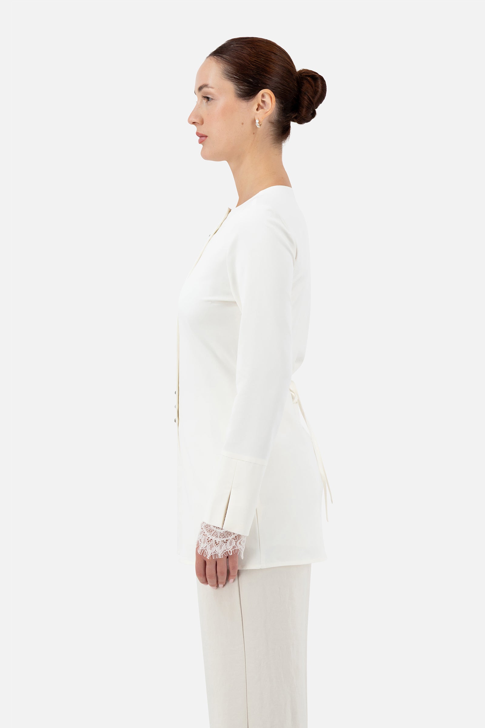 Side profile of the Sugar button-up long-sleeve top on the model.