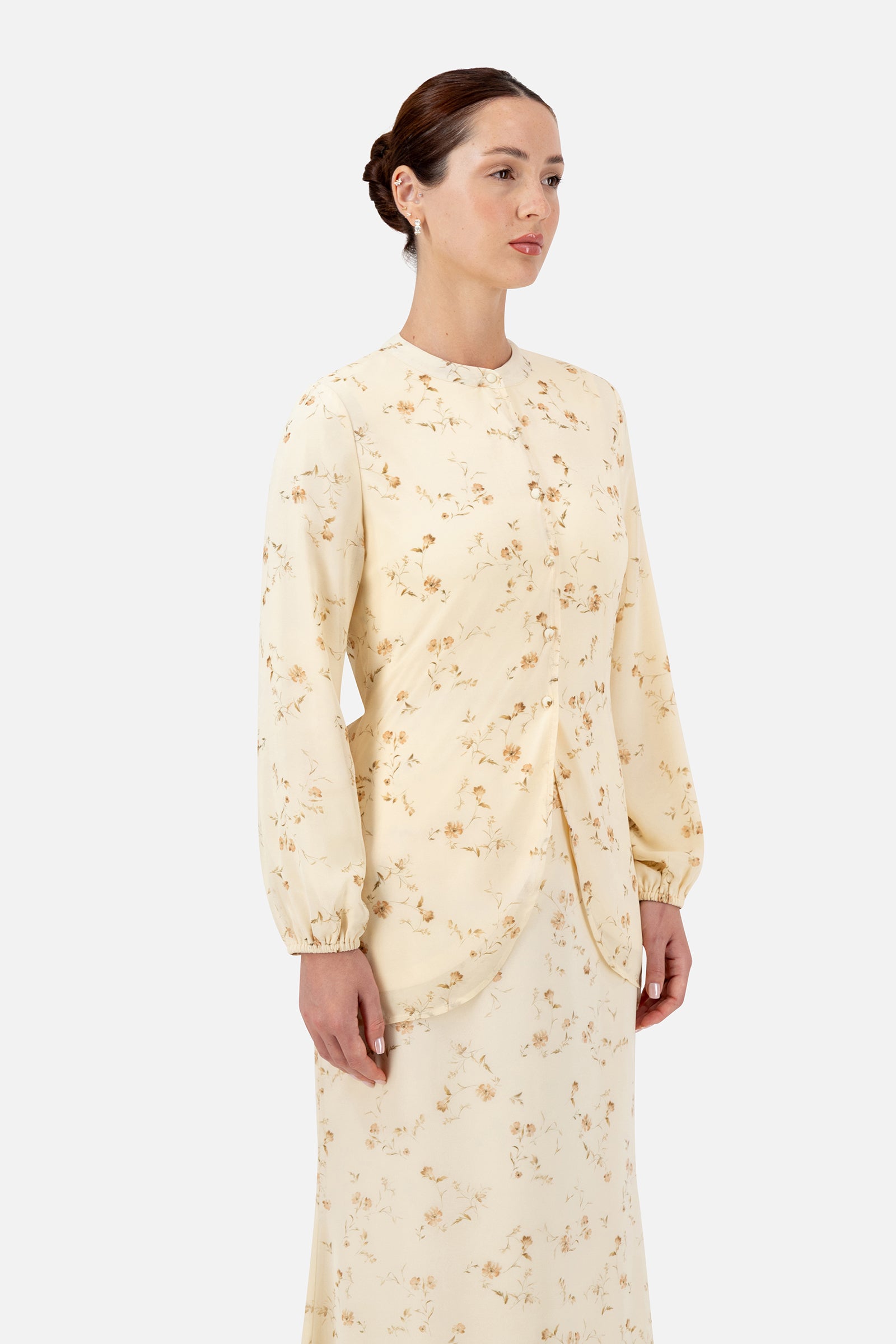 Woman standing in the Butterbloom blouse with a matching floral skirt.