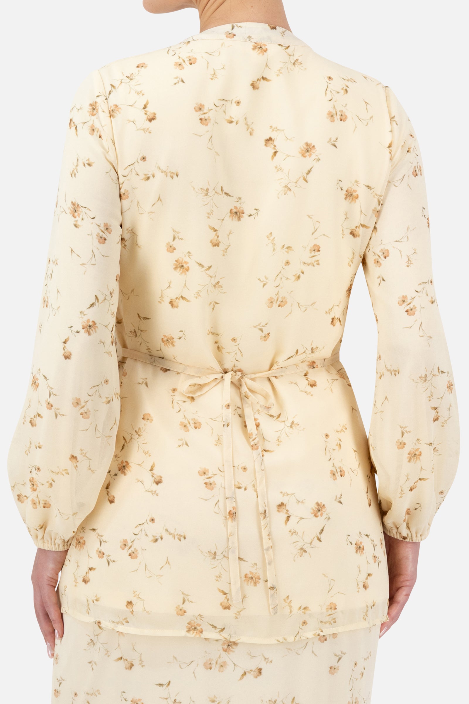 Close-up of the back detailing on the Butterbloom blouse with its soft floral pattern.