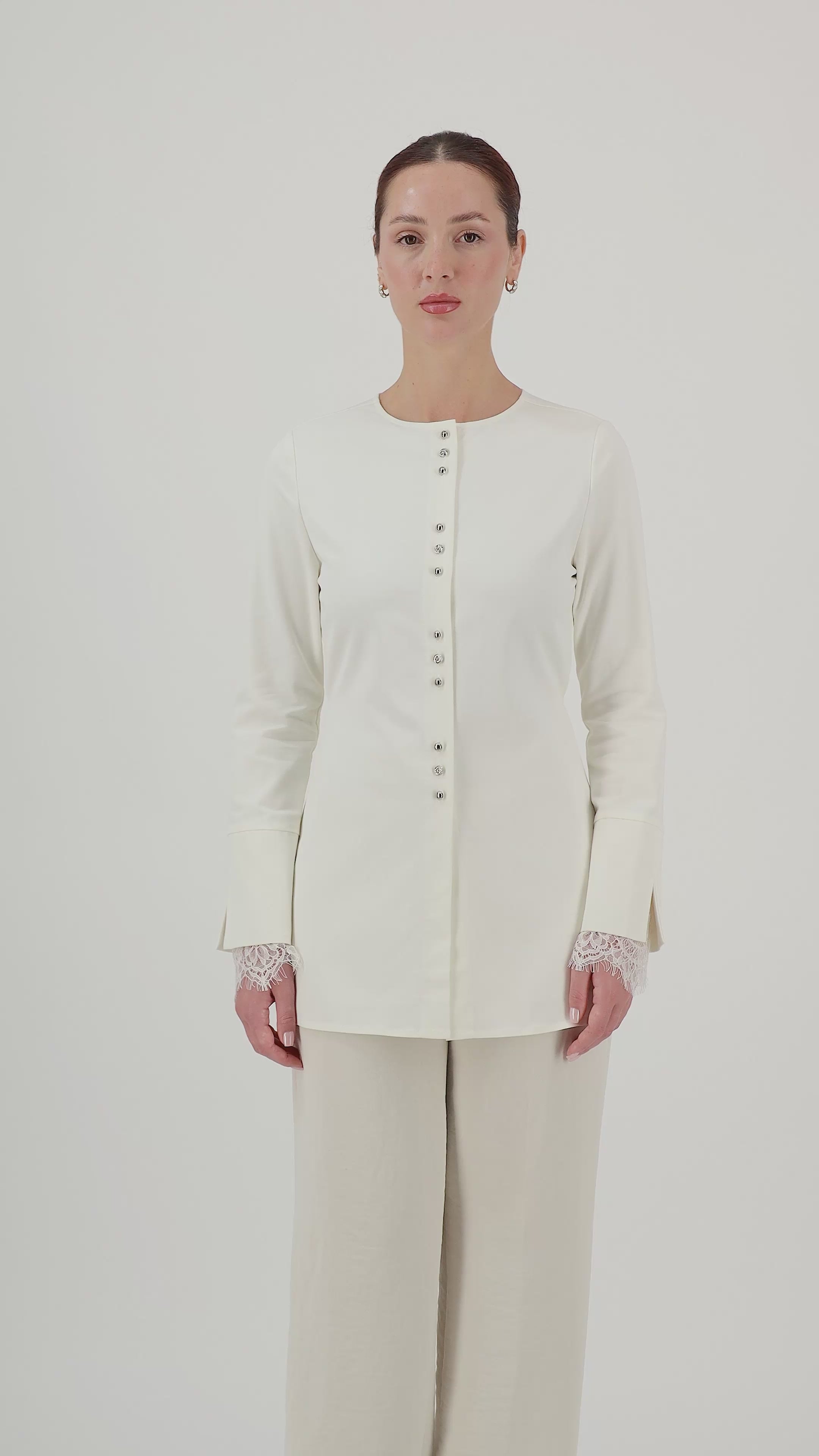 Model walks, turns from side to side and showcases the Sugar button-up long-sleeve top in motion.