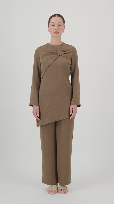 Model walks, turns from side to side and showcases the Espresso gathered ring asymmetric tunic in motion.