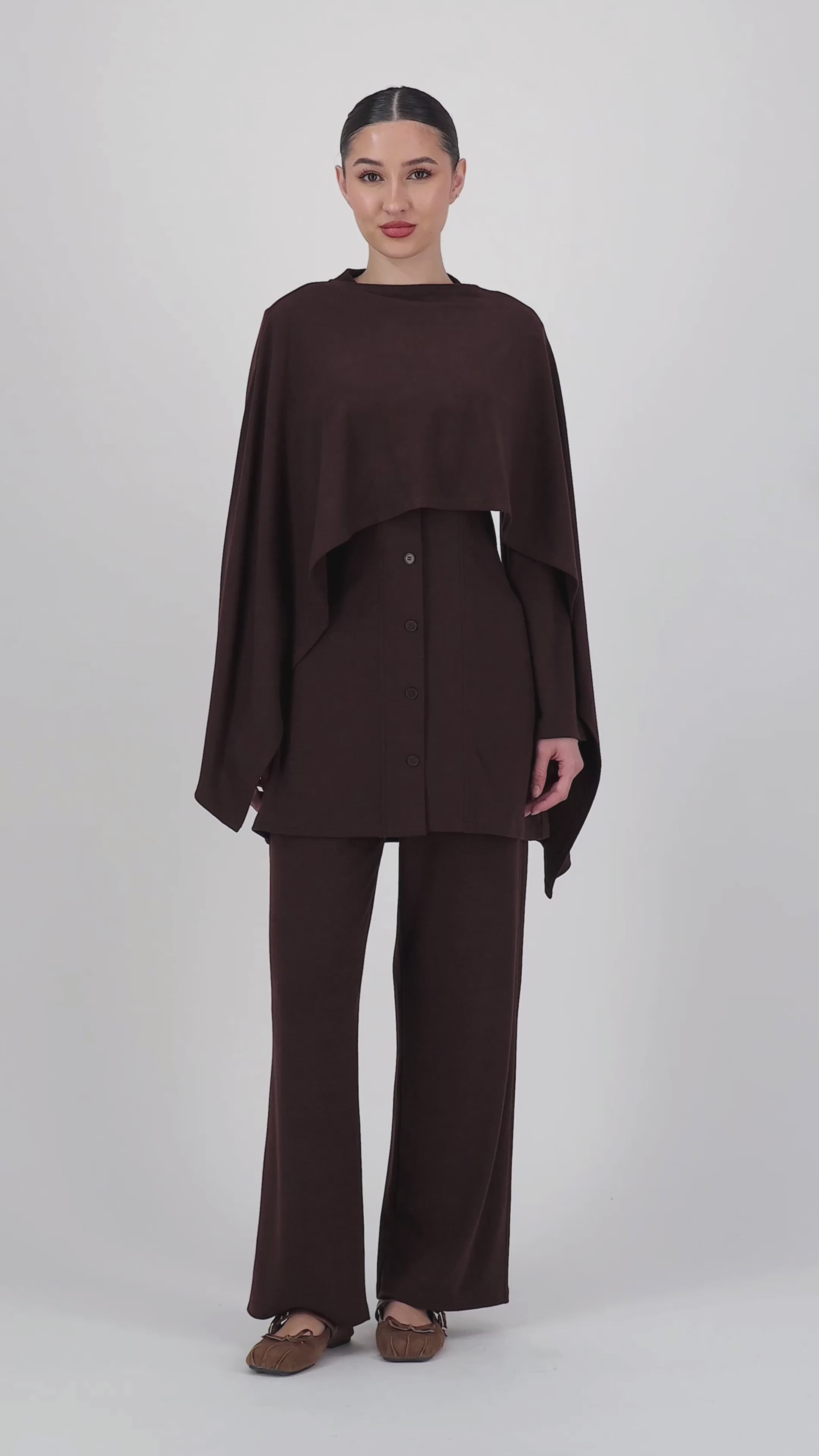 Video of the model moving in the Draped Shawl Knit Top Espresso, highlighting the soft drape and elegant neckline that define elevated tops for women.