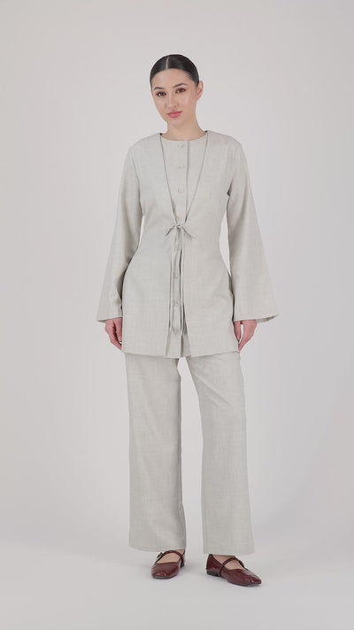 A model showcases the FARES Tailored Elastic Waist Pants in Chalk through natural movement, highlighting comfort, flow, and the ease of these wide leg elastic waist pants.
