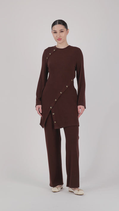 A model showcases the FARES Straight Leg Knit Pants in Brownie through natural movement, highlighting ease, flow, and the softness of these straight leg pants.