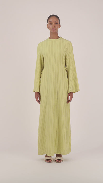 Video of a model walking in the lime FARES long sleeve maxi dress showcasing the fluid silhouette and elegant movement.