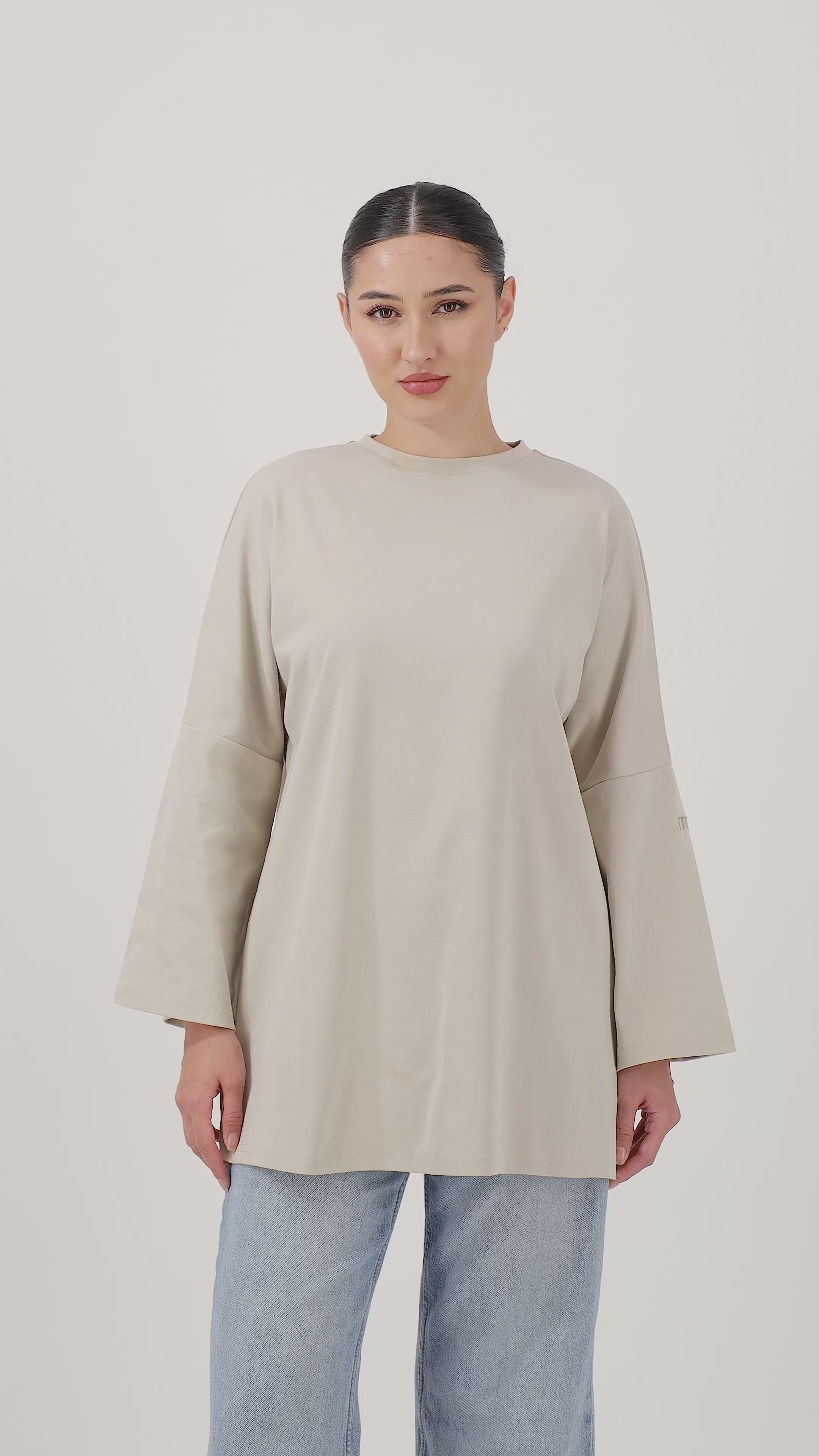 Model wearing the Mink Cotton Long-Sleeve Tee with relaxed movement and effortless everyday style.