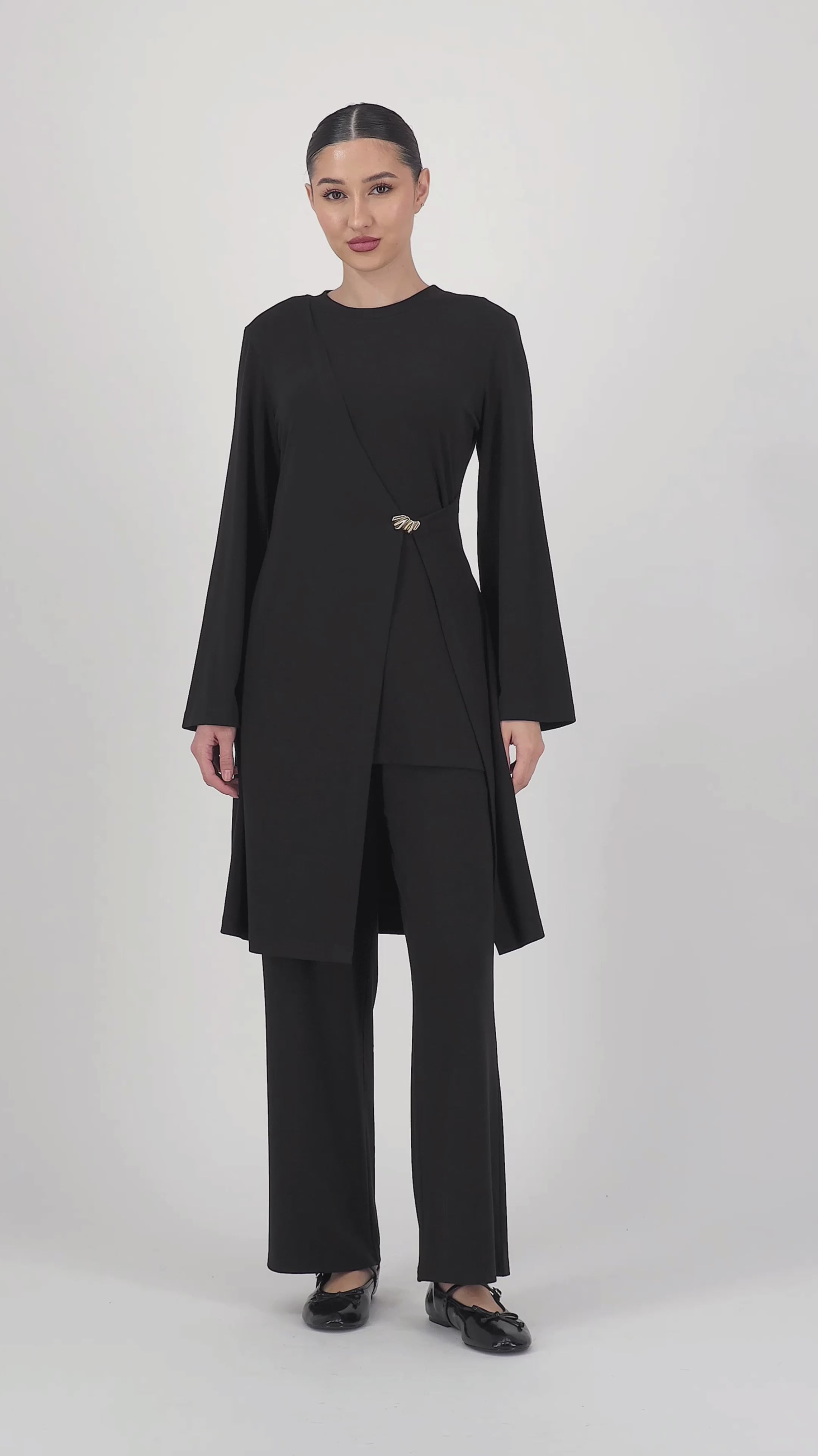 Video of the model moving in the Black Elastic Waist Straight Leg Trouser, showcasing the smooth drape and easy, elegant straight leg trouser silhouette.