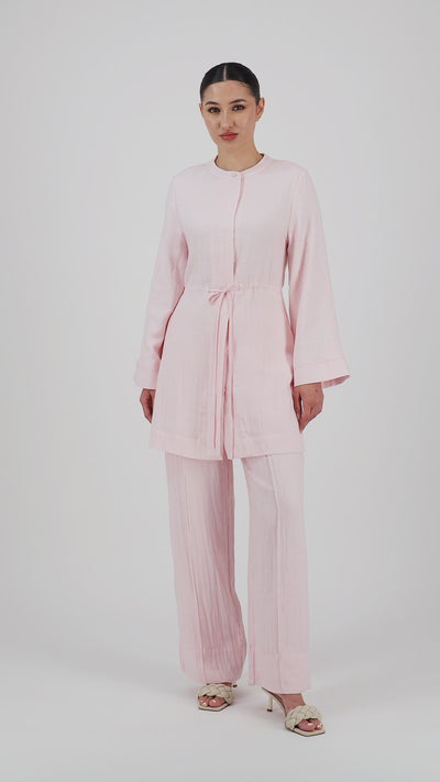 Video of a model walking in the FARES Drawstring Waist Button Up in Strawberry Cream showcasing the graceful movement of the tunic.