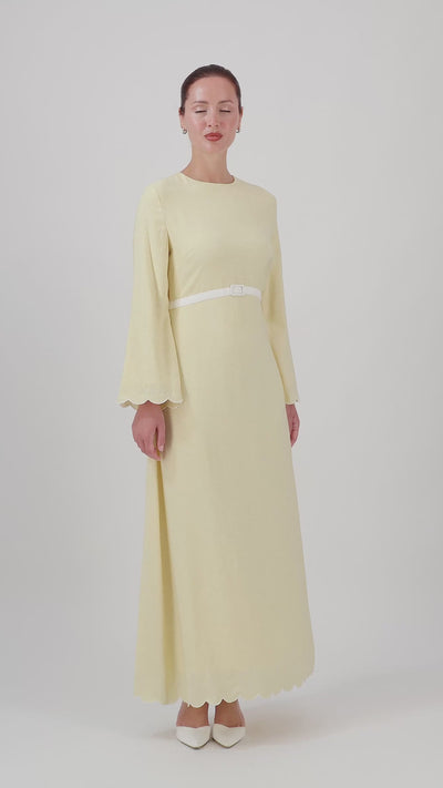 Video of the FARES Belt Detail Scalloped Dress in Buttercup, showing the flowing silhouette and delicate details of this summer dress.