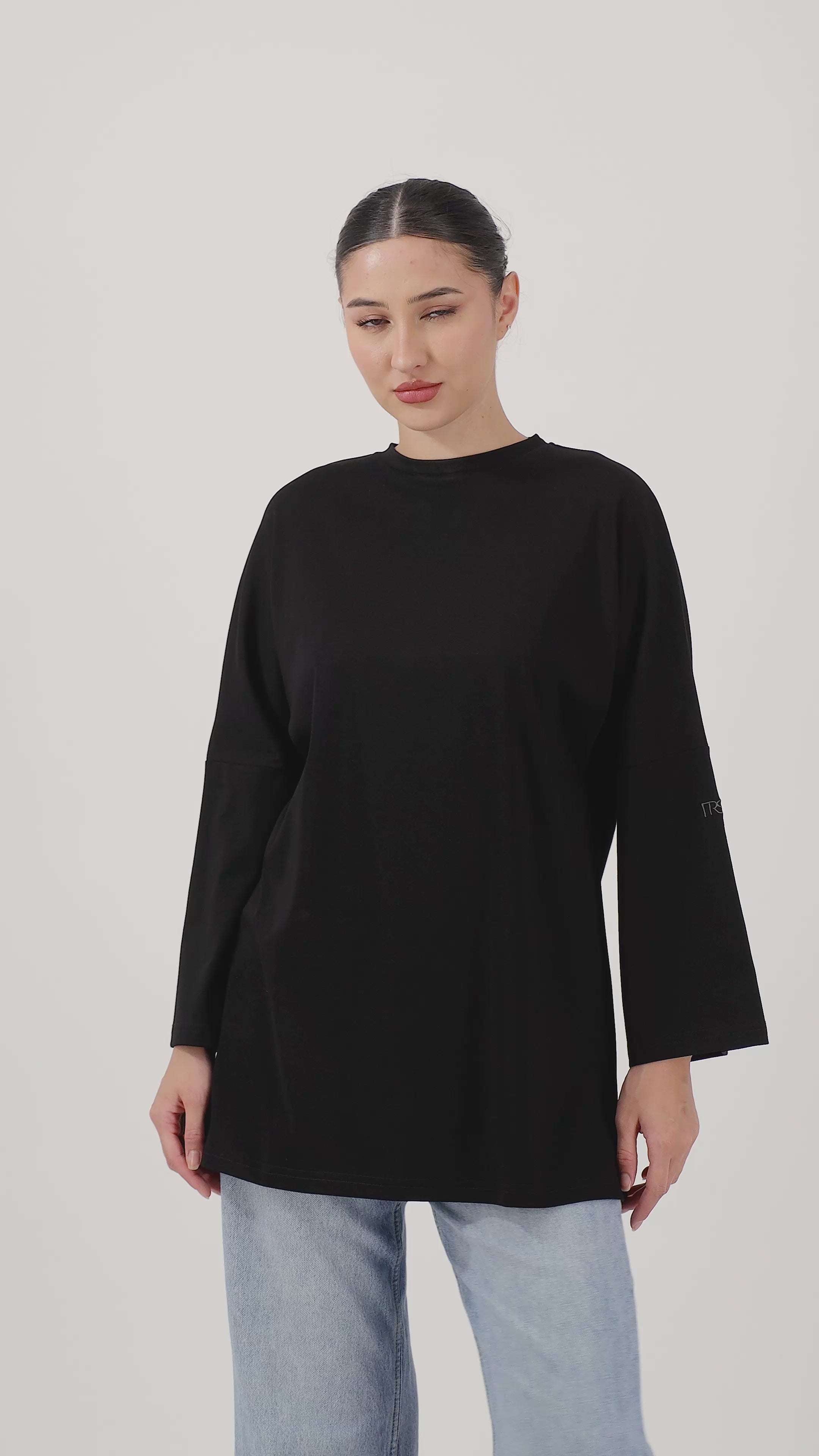 Woman wearing the Black Cotton Long-Sleeve Tee with effortless movement and everyday style.