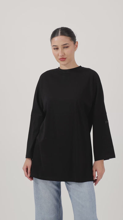 Woman wearing the Black Cotton Long-Sleeve Tee with effortless movement and everyday style.