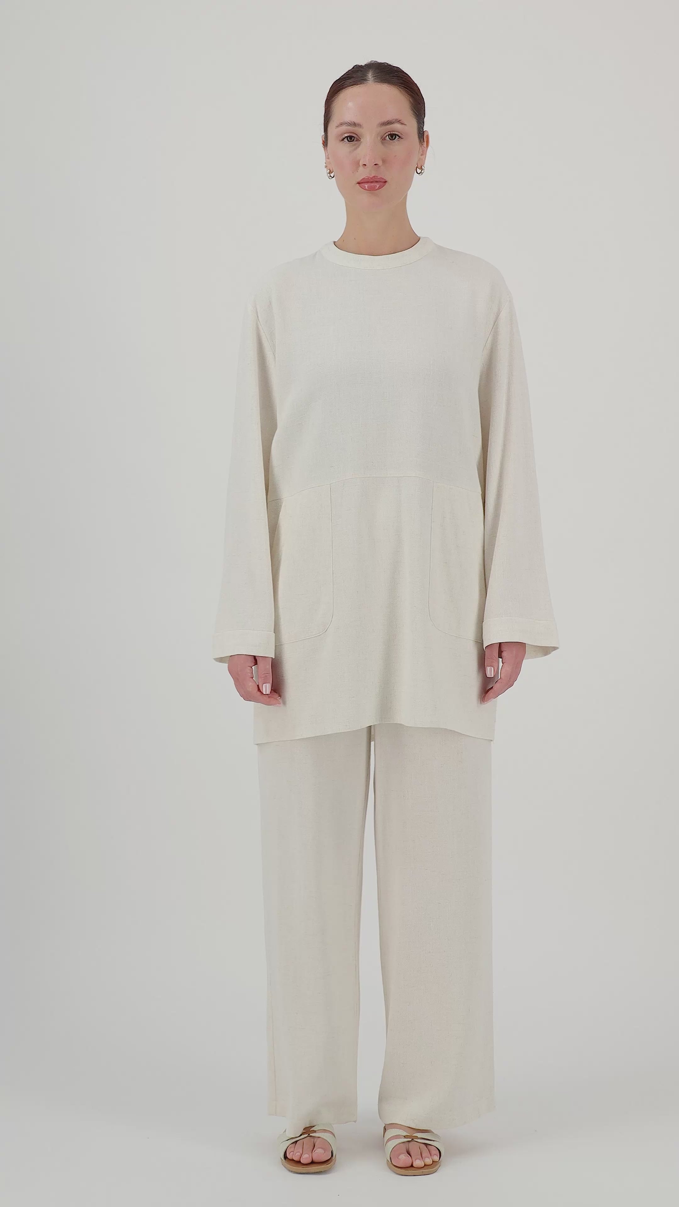 Model walks, turns from side to side and showcases the Vanilla linen blend pants in motion.