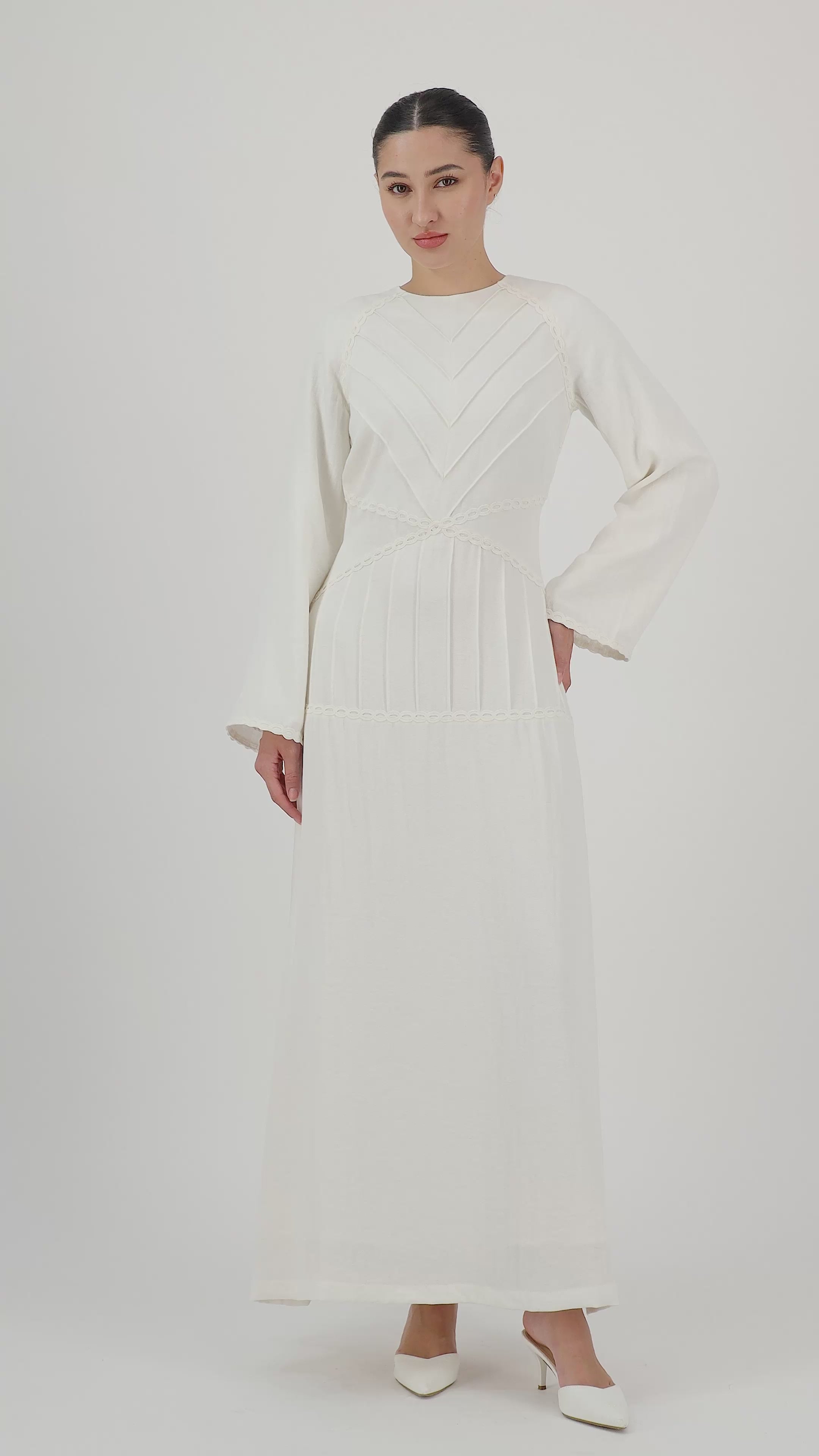 Model walks, turns from side to side and showcases the White Ivory geometric detail maxi dress in motion.