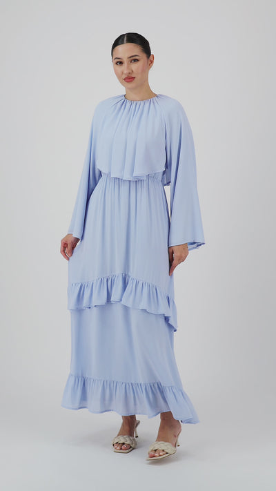 Video of a model walking in the FARES Chiffon Layer Dress in Powder Blue showcasing the flowing movement of this maxi dress.